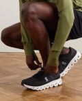 On Cloudflow 4 Black White Running Shoes product image 1, provided for visual reference and product detail review
